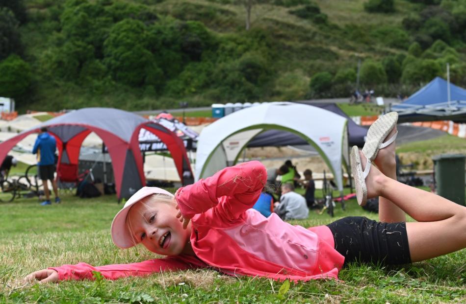 Grace Kerr (8), of Invercargill, takes time out to roll down a hill.
