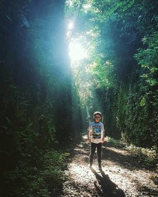 Fletcher La Roche (9) enjoys the rays of light in the otherwise dark Caversham tunnel entrance. Photo: Alex La Roche