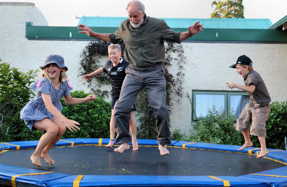 Ronald Clark jumps on a trampoline with grandchildren (from left) Sienna Clark (8), of Wanaka,...