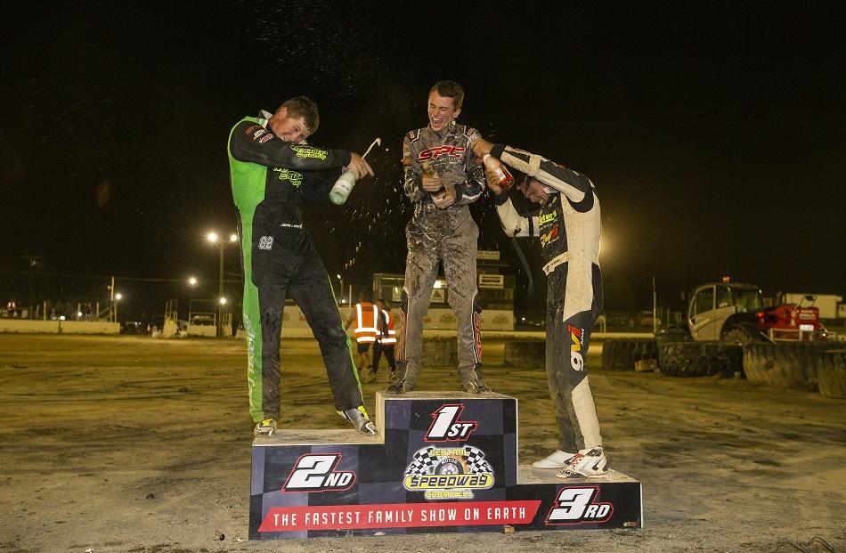 Celebrating on the podium are (from left) Jamie Larsen, Buddy Kofoid and Michael Pickens.  Photo:...