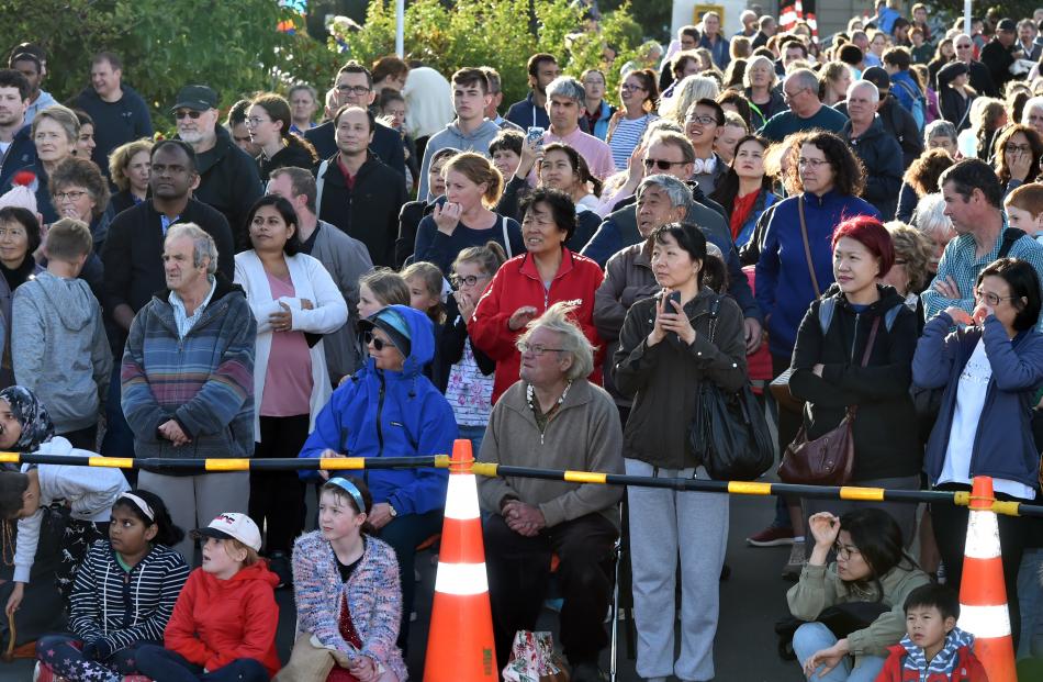 Some of the large crowd at the Dunedin Chinese Garden watch the vivid spectacle.