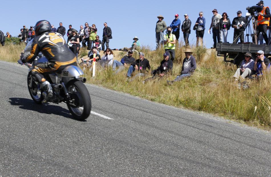 Spectators watch as Butch Woods from Alexandra motors his 1970 Norton Commando 750 up the first...