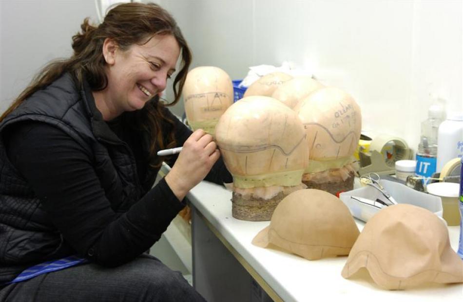 Louise Schumacher marks out a silicone cap.