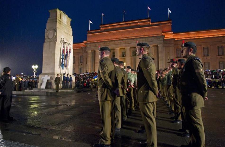 Soldiers and veterans stand in the rain at the Dawn Service, War Memorial Museum. NZPA / David...
