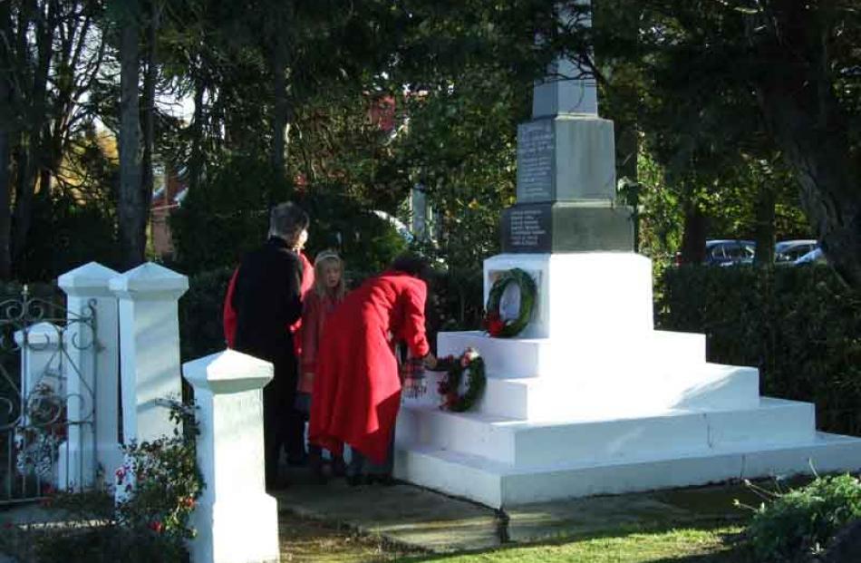 Members of the public lay wreathes and poppies at the remembrance service at Lovell's Flat, near...