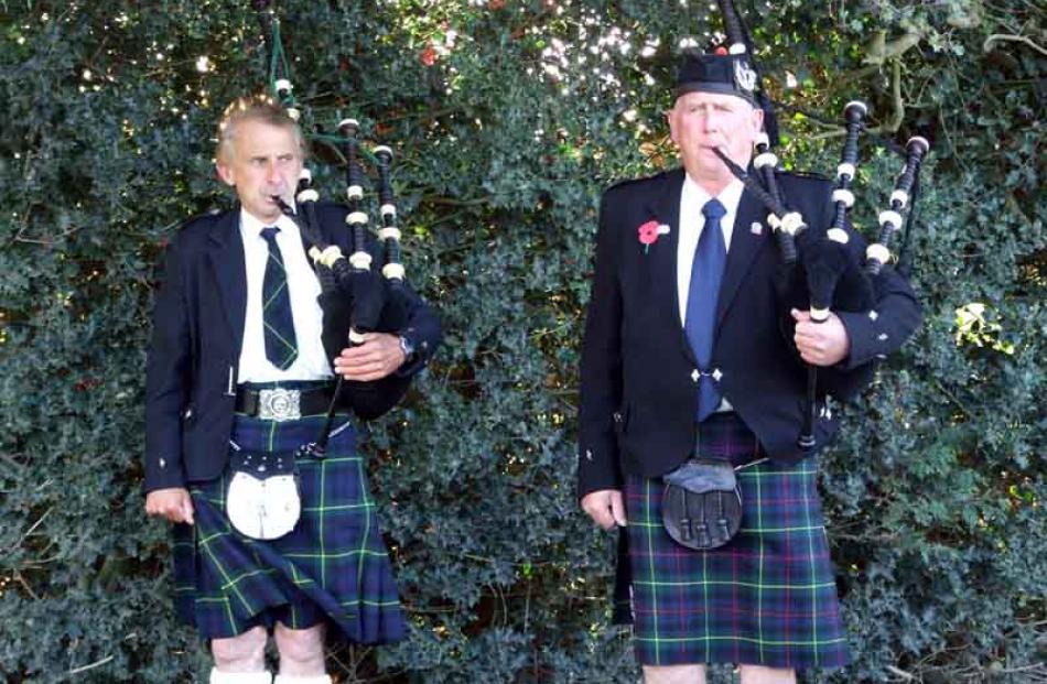 Johnny McIntyre, of Taeri, and Donald Wilson, of Hillend, brave the biting wind while piping...