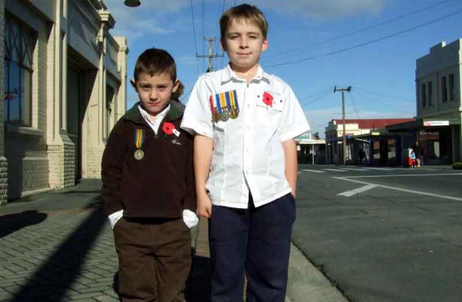 Cousins Seth Rogan (6), of Milton with his great great uncle's medal, and Jordan Rogan (9), of...