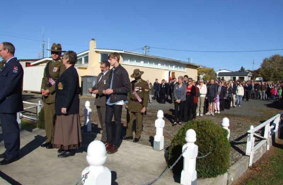 The Waikouaiti Anzac day parade and wreath laying. People are queuing to place their poppies on...
