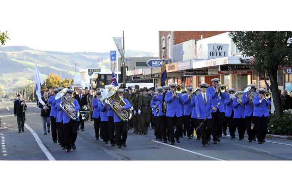 The Mosgiel Brass leads the ANZAC Day parade up Gordon Road to the Mosgiel war memorial yesterday...