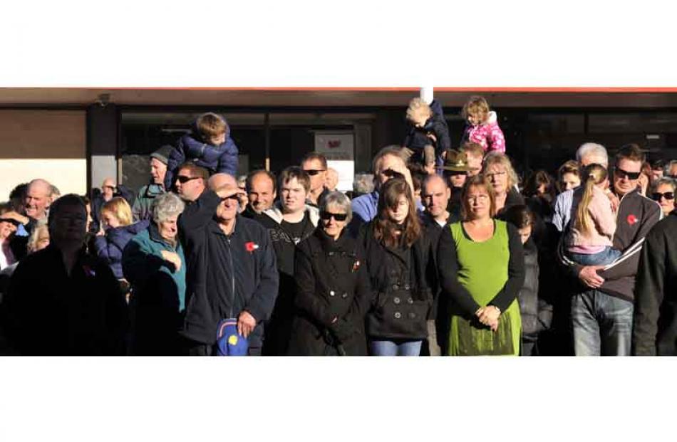 Part of the crowd watch the ANZAC Day service at the Mosgiel War Memorial yesterday morning....