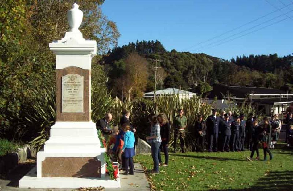 Mikey Rainbow, Steven Rainbow and Elsa Neuman lay a wreath at the Waitati cenotaph on behalf of...