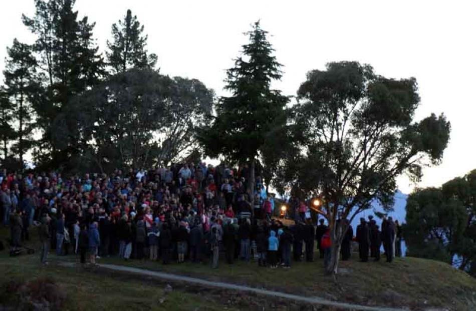 Lakeside remembrance . . . About 250 people gathered on the rocky headland and cenotaph flagpole...