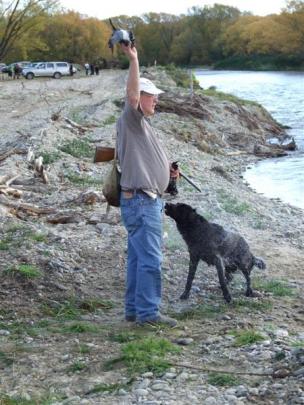 Tony Hogarth, of Christchurch and his Labrador Hurleyhall Viking compete in the water leg of the...