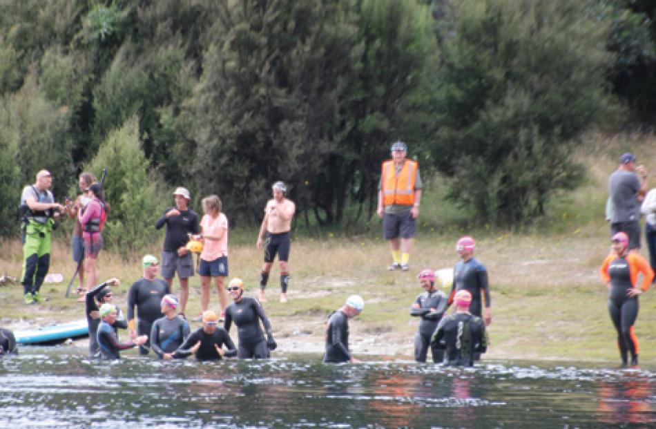 Swimmers entering the water in the Upper Waiau River at the Control Gates in Te Anau for the...