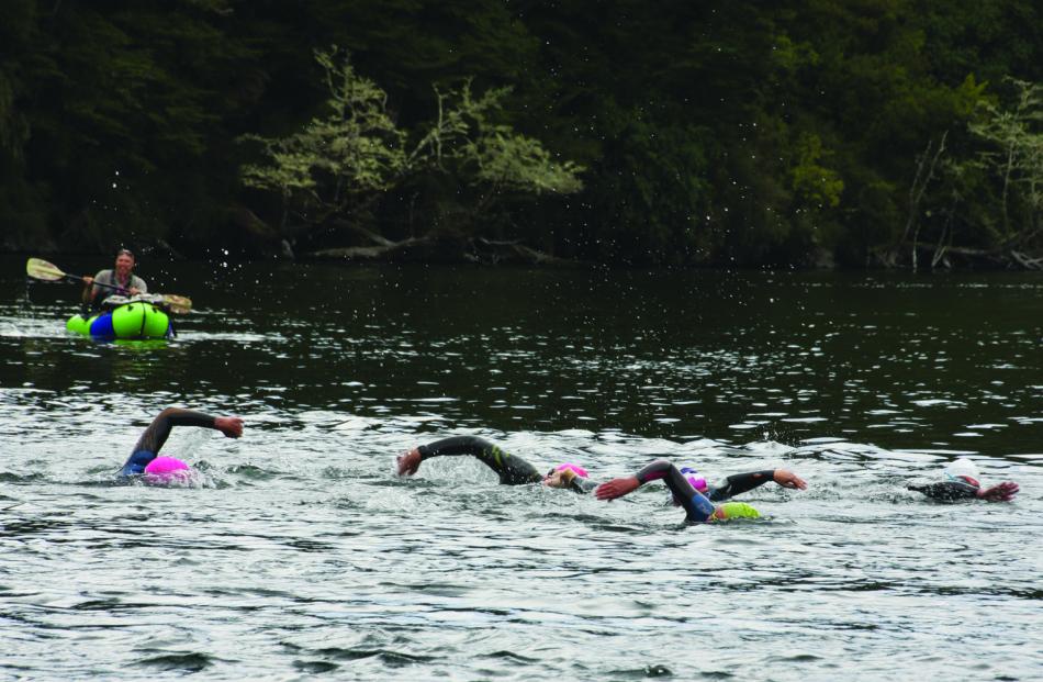 Swimmers navigating the Upper Waiau River during the “fast” swim, with all swimmers having...