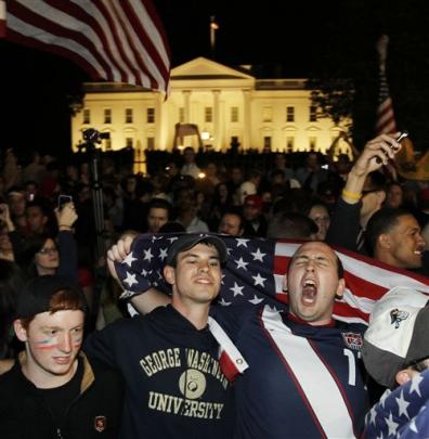 Crowds celebrate on Pennsylvania Avenue in front of the White House in Washington. (AP Photo...