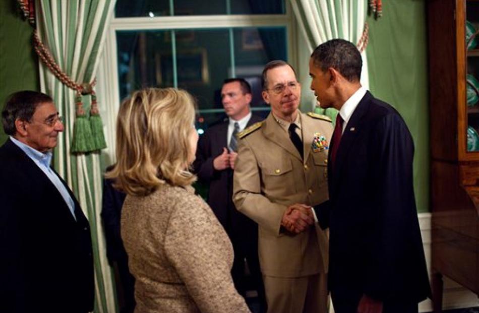 US President Barack Obama shakes hands with Admiral Mike Mullen, Chairman of the Joint Chiefs of...