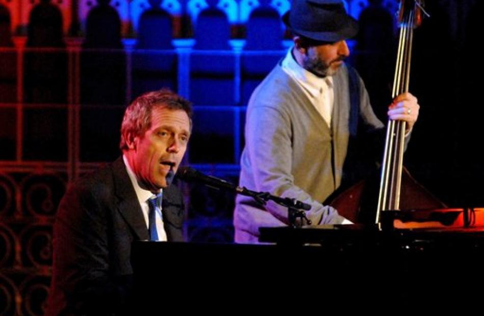 British actor Hugh Laurie plays piano as he performs with other musicians at the Union Chapel in...