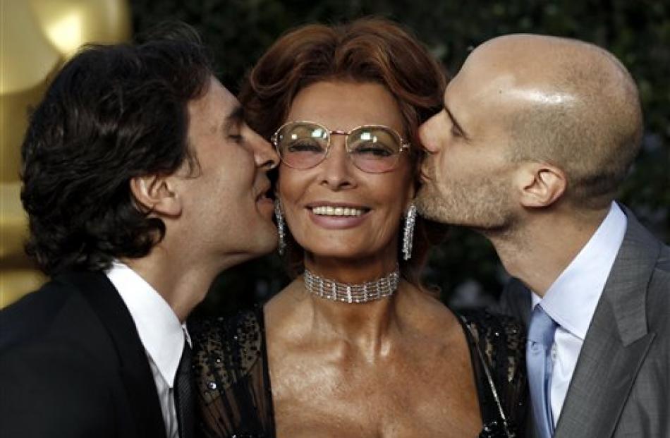 Sophia Loren gets a kiss from her sons, Carlo Ponti Jr, left, and Edoardo Ponti at The Academy of...