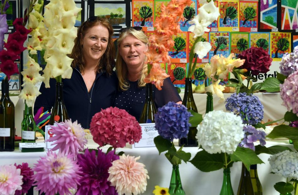 Toni Caldwell (left) and Char Taylor, both of Queenstown, enjoy the flower entries in the home...