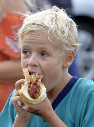 East Taieri School's Matthew Hanna tucks into lunch after finishing his race.