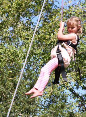 4 year old Lucy Hansen of Te Anau flying through the air on the Flying Fox.