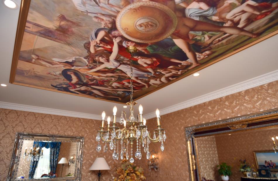 A painting is mounted on the ceiling in one of the living areas. 