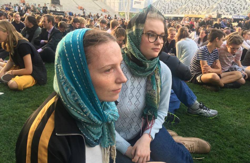 Emily Wood (left) and Thea Bailie-Bellew are among many wearing hijabs in solidarity with the...
