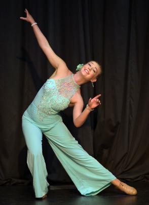 Sarah McLennon (17) slides along the stage.