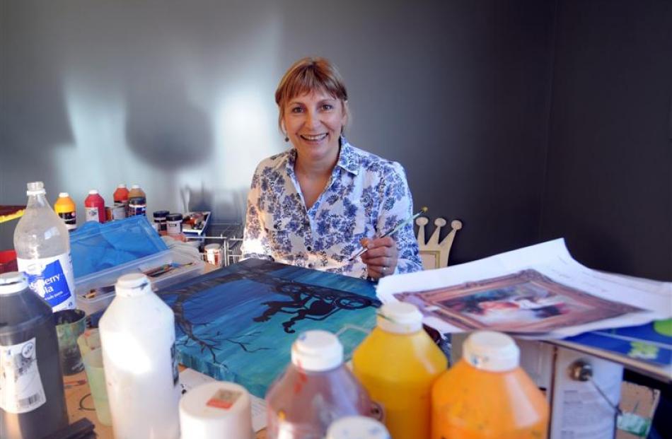 Lauren Bremner paints in her studio.