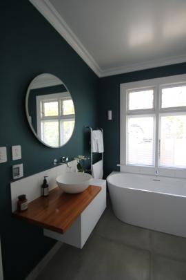 The basin in the family bathroom echoes the circular mirror above it. 