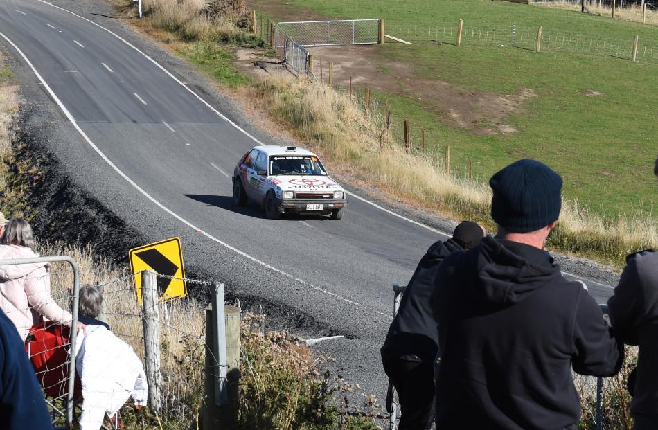 A crowd of spectators look on as a vehicle races along McIntosh Rd on Saturday.PHOTO: GREGOR...