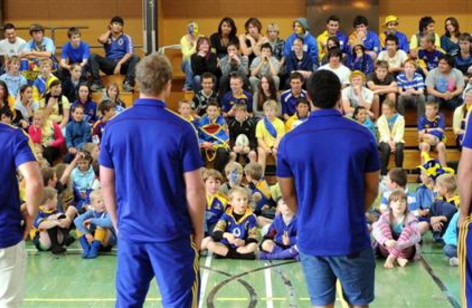 Highlanders  (from left) Shaun Treeby, Kendrick Lynn, Lima Sopoaga and Ben Smith talk to...