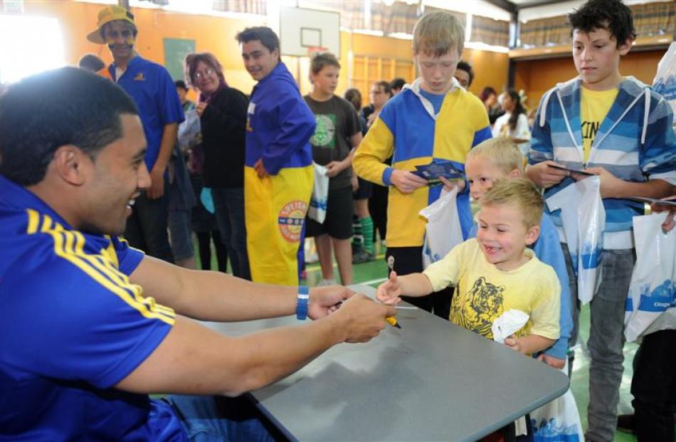 Oliver Geddes (5)  has his day made by an autograph from Lima Sopoaga  at Maniototo Area School.