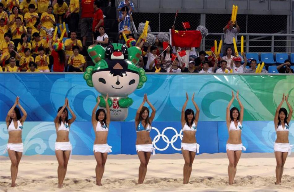 Chinese cheerleaders rehearse with test matches at the Beach Volleyball venue for the Beijing...