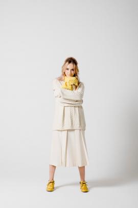 ‘‘The Aran handknit Jersey and New Zealand-made cream wool pleat skirt with vibrant pop yellow,...