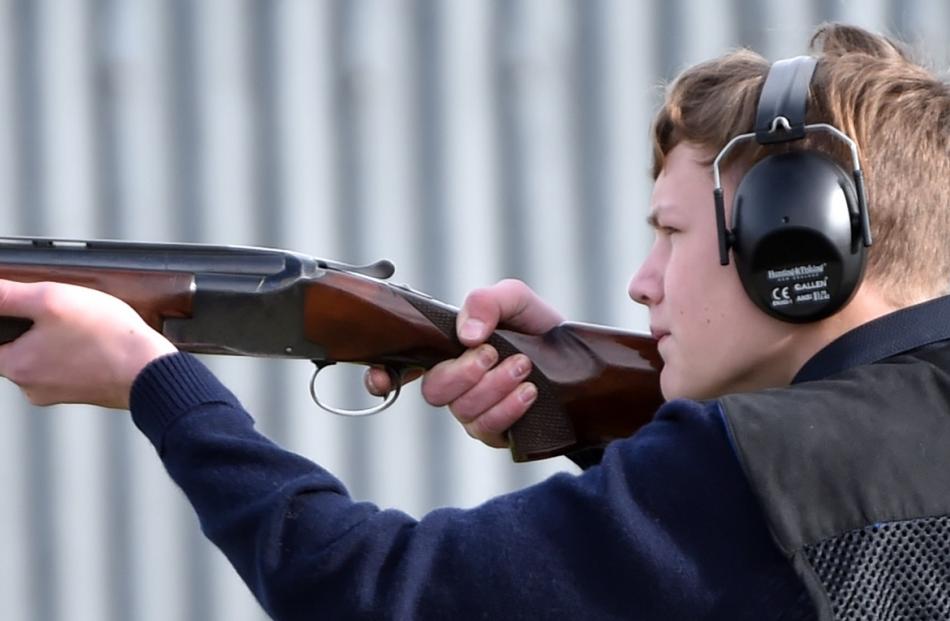 King's High School trap shooter Ted Cottle (13) takes aim in the trap shooting contest at the...