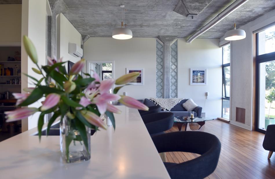 Glass doors and windows cut in the front wall bathe the interior in natural light. 
