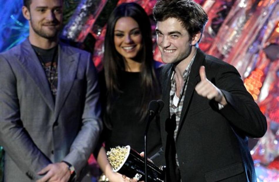 Robert Pattinson accepts the award for best male performance at the MTV Movie Awards in Los...