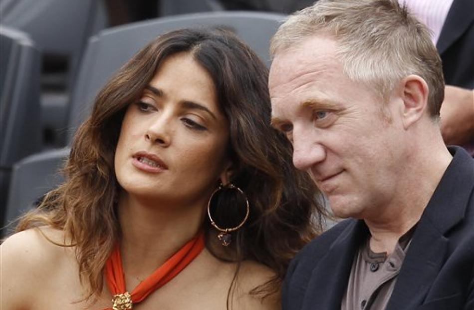 Actress Salma Hayek and her husband Francois-Henri Pinault watch Roger Federer playing Novak...