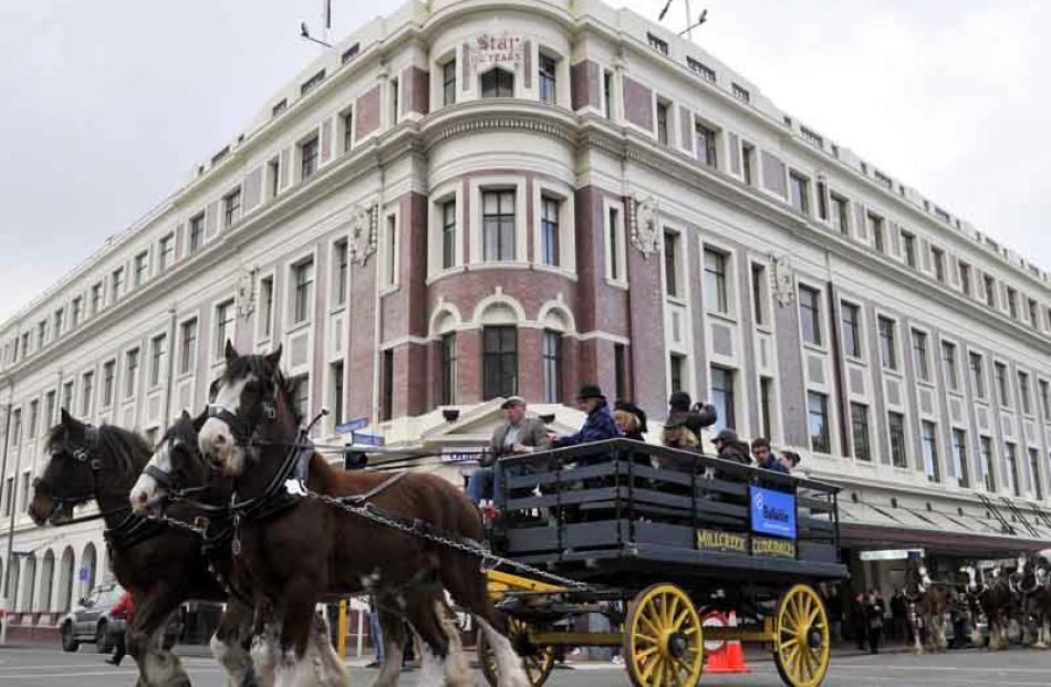 The street parade passes the Otago Daily Times building in Stuart St.