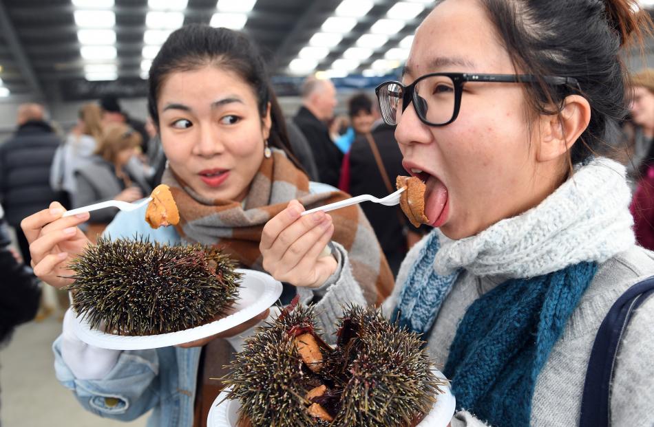 Milu Zhuo and Amber Leung, both living in Queenstown, enjoy a kina snack.