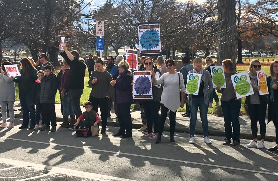 Alexandra: Nearly 100 school staff from Alexandra and Clyde exhibit banners in full view of motorists yesterday. Photo: Adam Burns