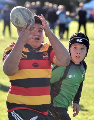 Zingari Richmond U11 player Ratana Jah Kahukura (11) juggles the ball as Alexandra's Alex Scott ...