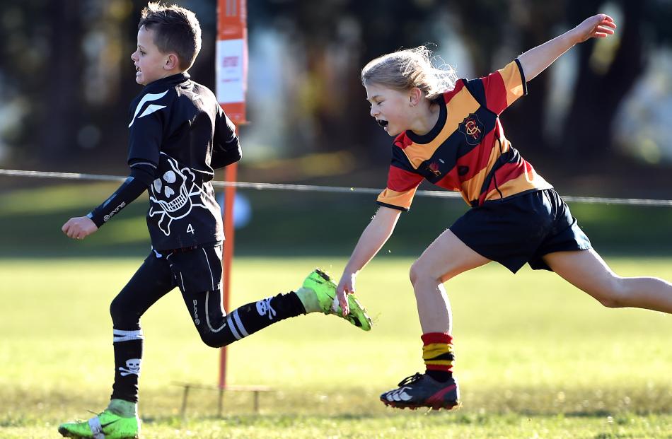 Reaching out in vain is Zingari Richmond U9 player Brooke Ratten-Johnson (8) as she tries to...