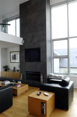 A central two-storeyed volume connects the living spaces while the towering chimney breast houses...