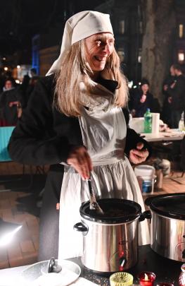 Greta Doo waits to serve mulled wine to thirsty onlookers. 