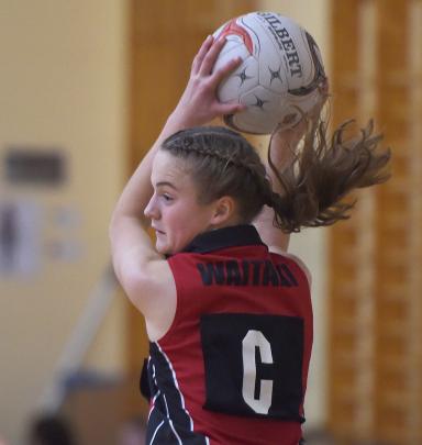 Waitaki Girls’ High School centre Sarah Jamieson (13) takes the ball in the match against Queen’s...