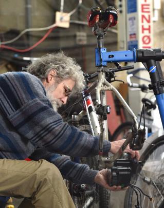 Engineer and bike specialist Steve Ward fits an electric motor to a pushbike. 