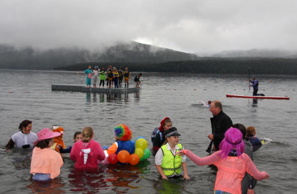 Student plungers enjoying  the lake after a chiily dip but didn’t seem to deter them. According...